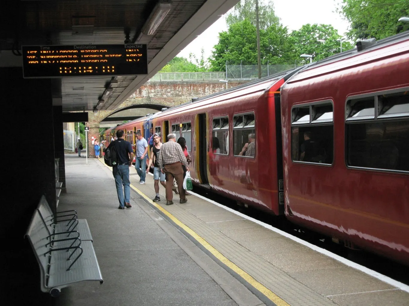 Passengers beside a train at Bracknell station