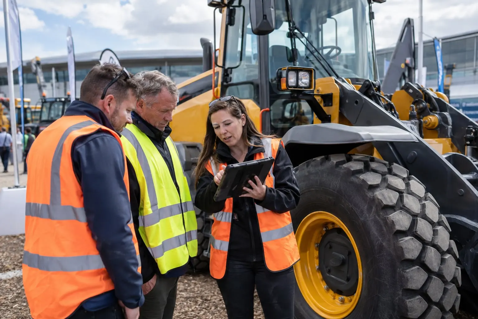 Illustrative plant telematics discussion beside a stationary loader