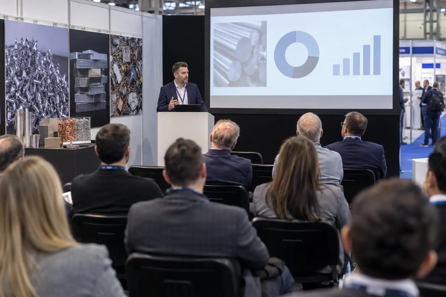 Illustrative metals supply-chain seminar with speaker and audience