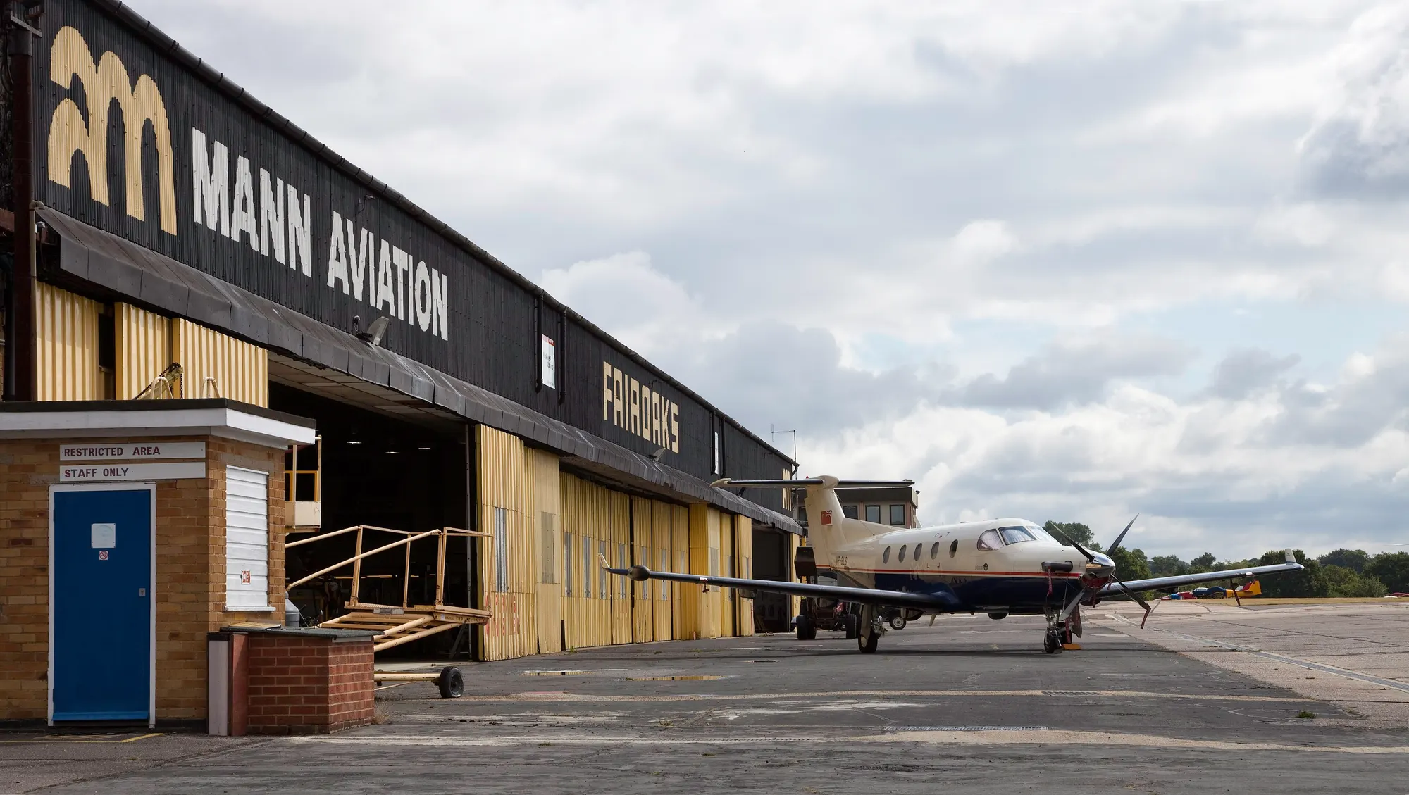 Archival photograph of a Fairoaks Airport aviation hangar and parked aircraft