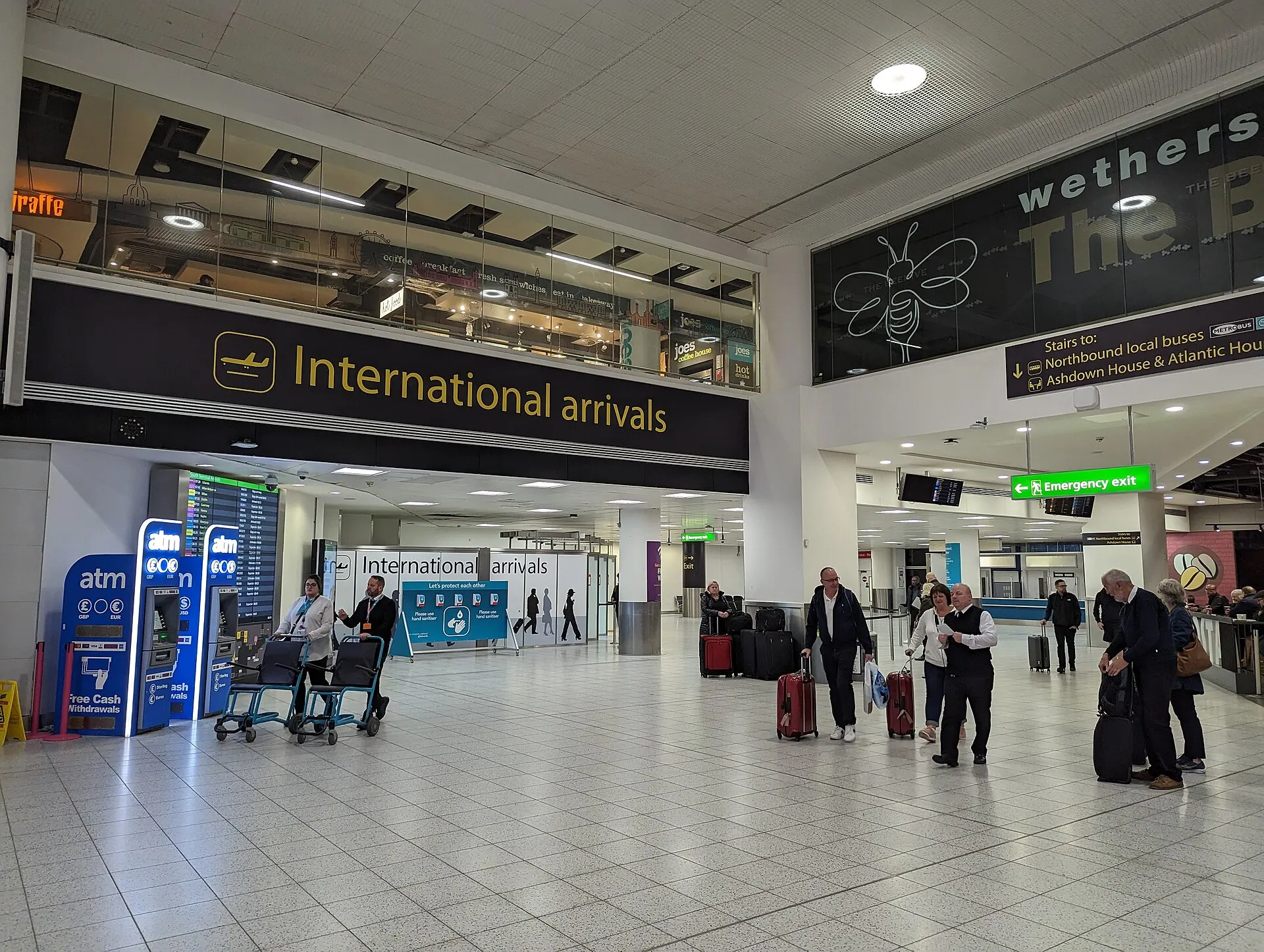 Public international-arrivals exit inside Gatwick South Terminal photographed in November 2022; follow current meeting signs