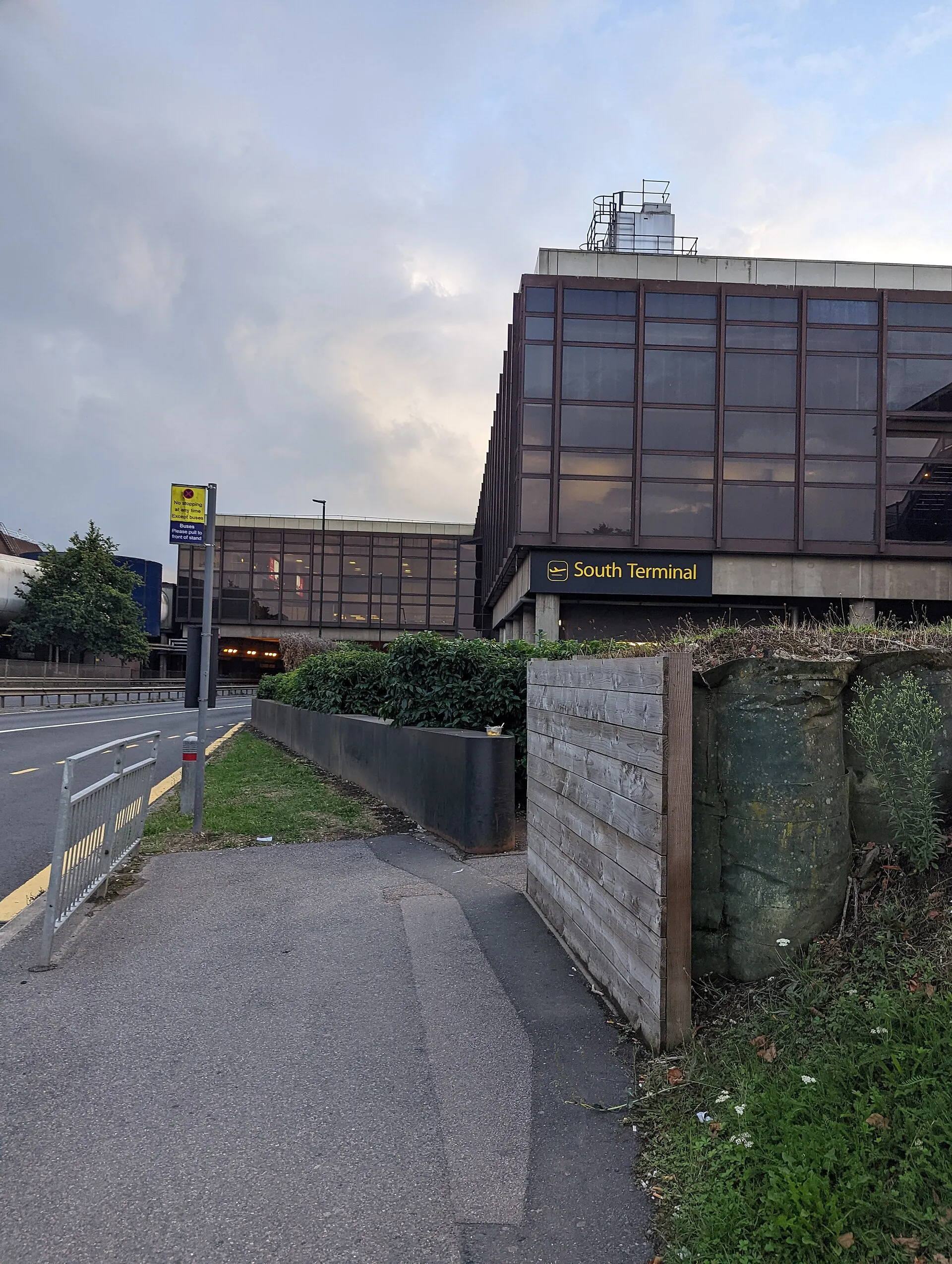 Gatwick South Terminal building viewed from a nearby bus stop in September 2022; not current vehicle-lane guidance