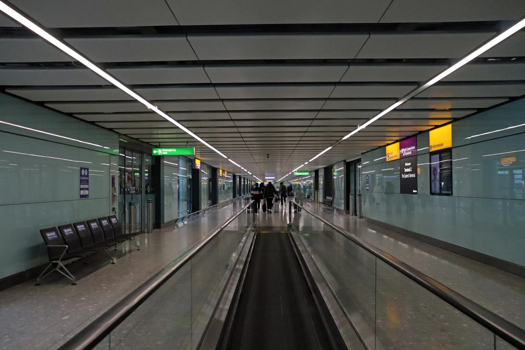 Heathrow Terminal 2 arrival corridor before the border checkpoint photographed in November 2025; this is not the public meeting hall