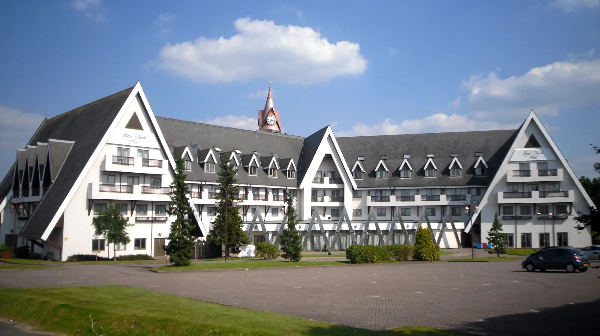 Coppid Beech Hotel's white Alpine-style facade and clock tower photographed in 2012