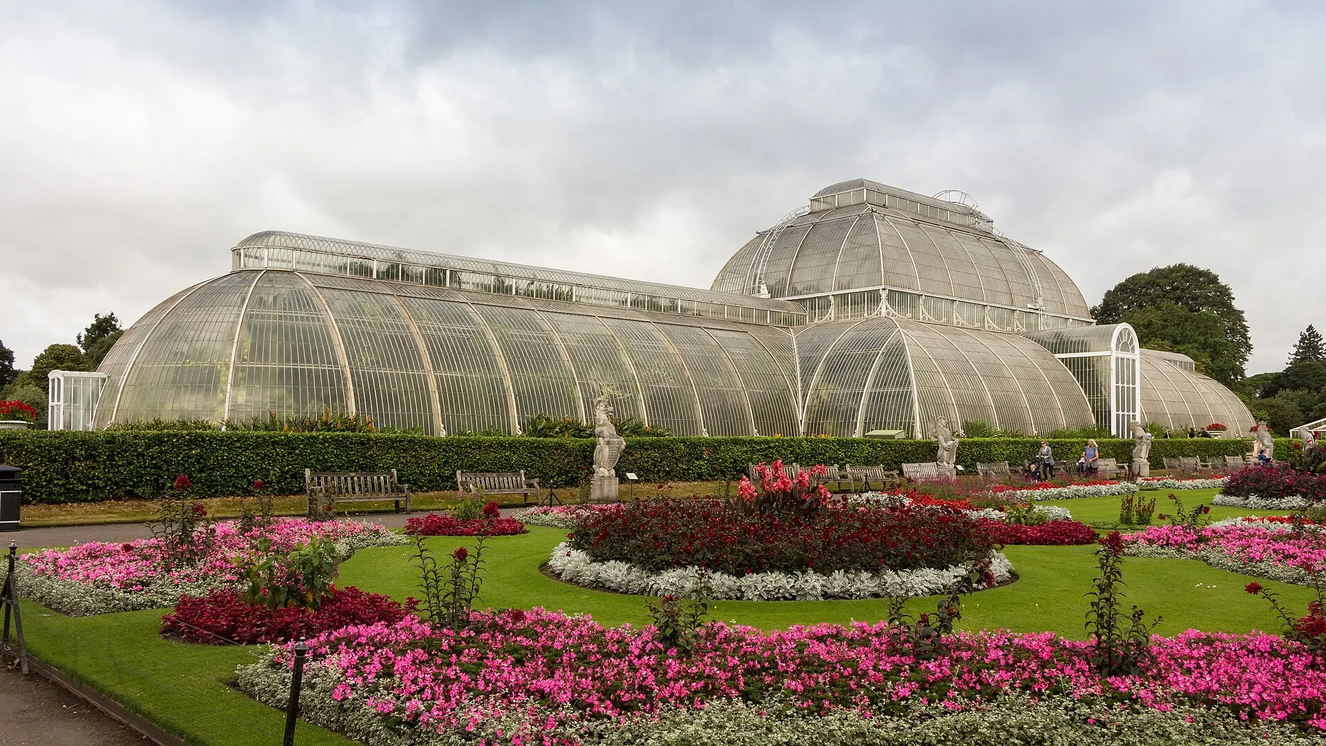 Palm House and flower beds at Kew Gardens in a 2016 photograph
