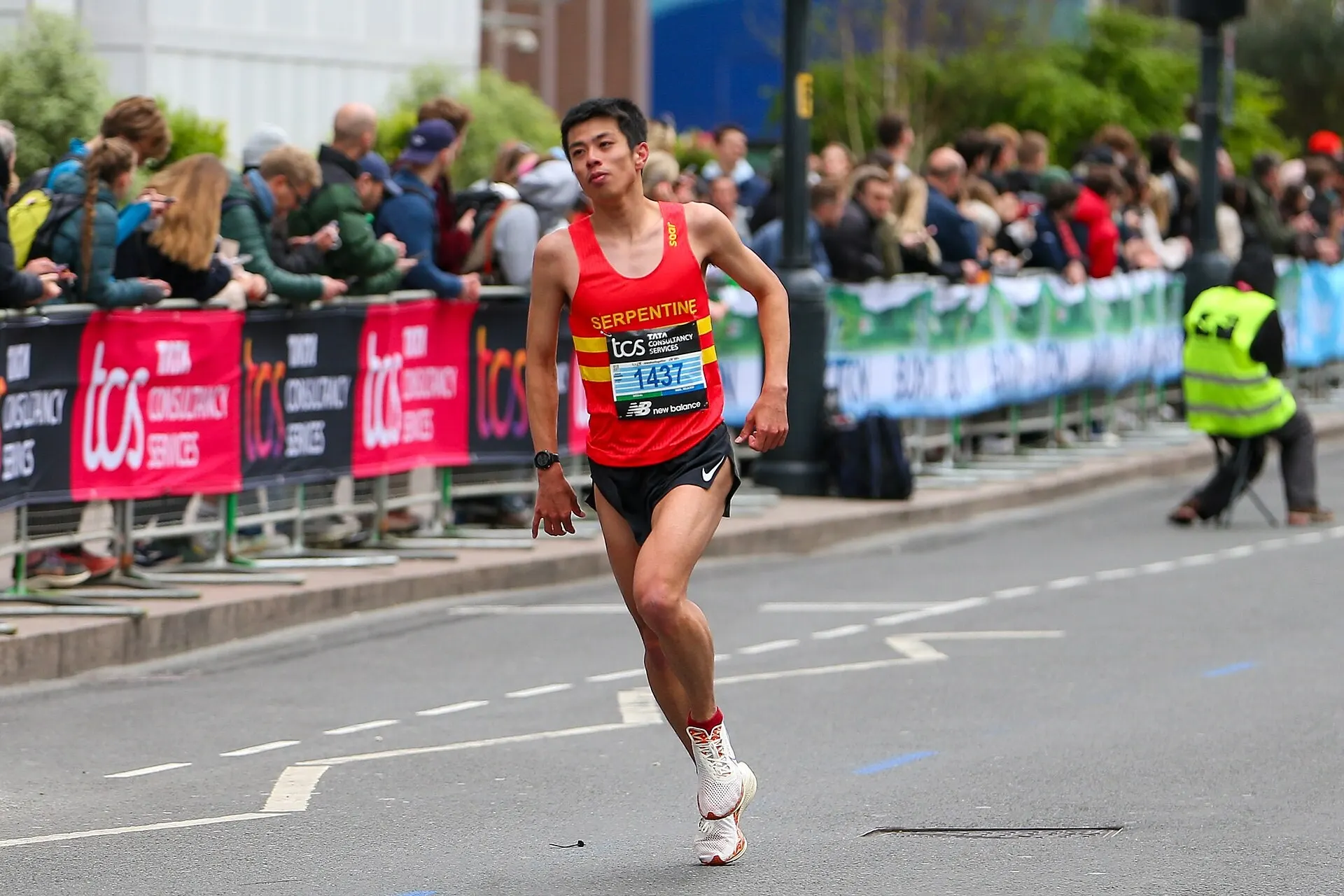 A runner and roadside supporters at the 2024 London Marathon