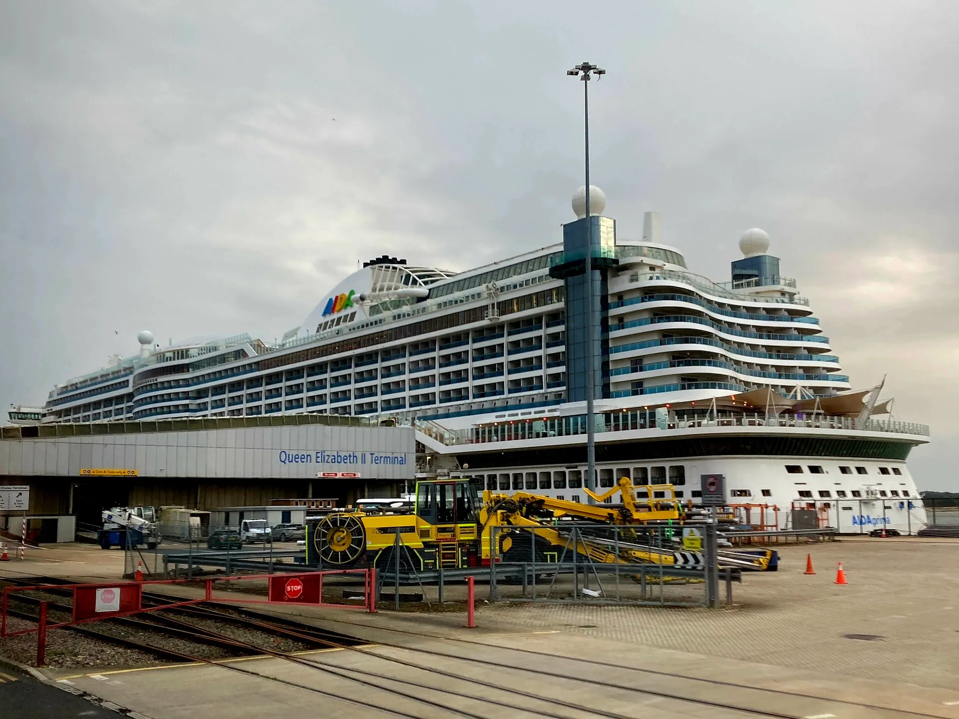 AIDAprima alongside the signed Queen Elizabeth II Cruise Terminal at Southampton in August 2024