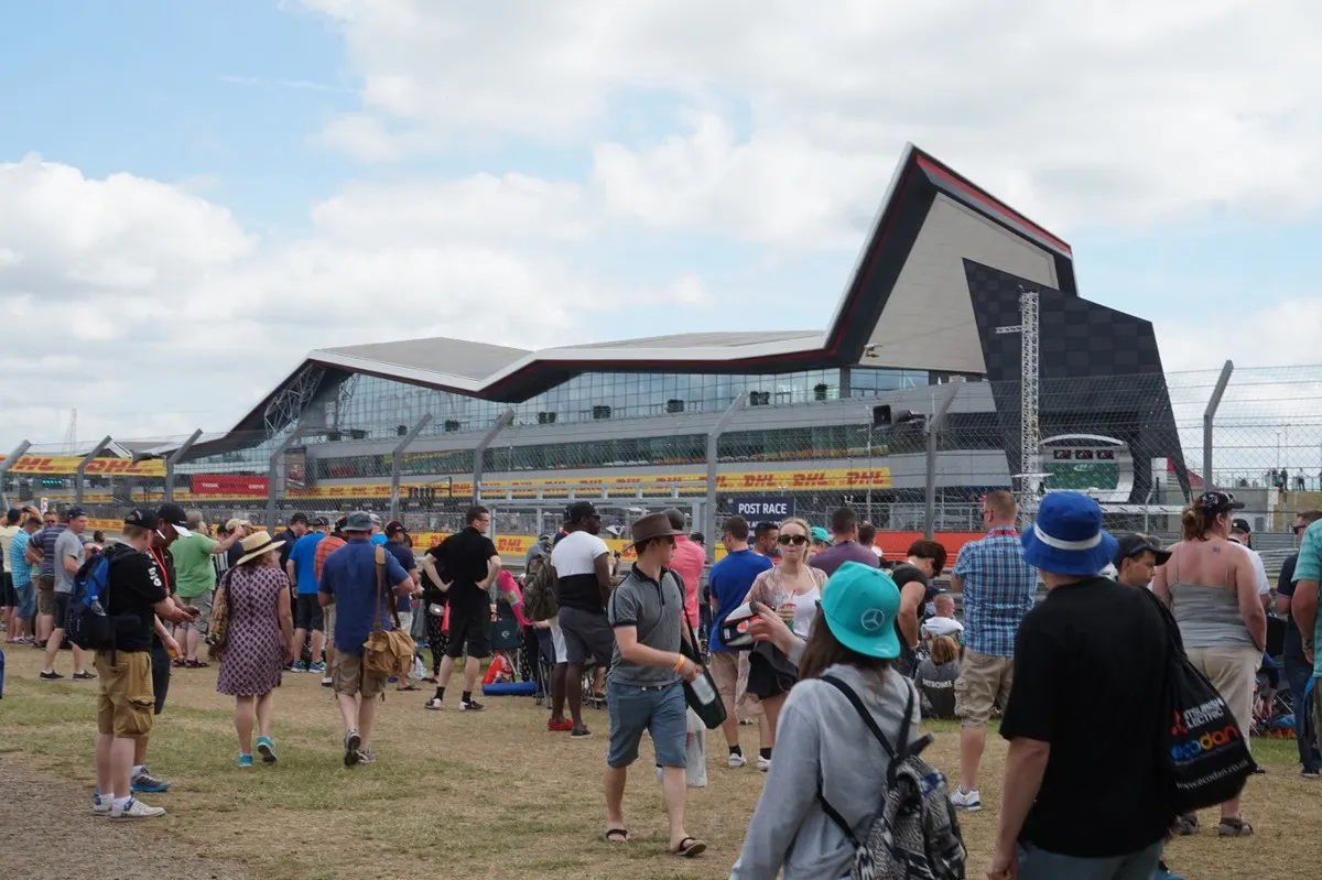 Visitors walking towards the Silverstone Wing paddock building