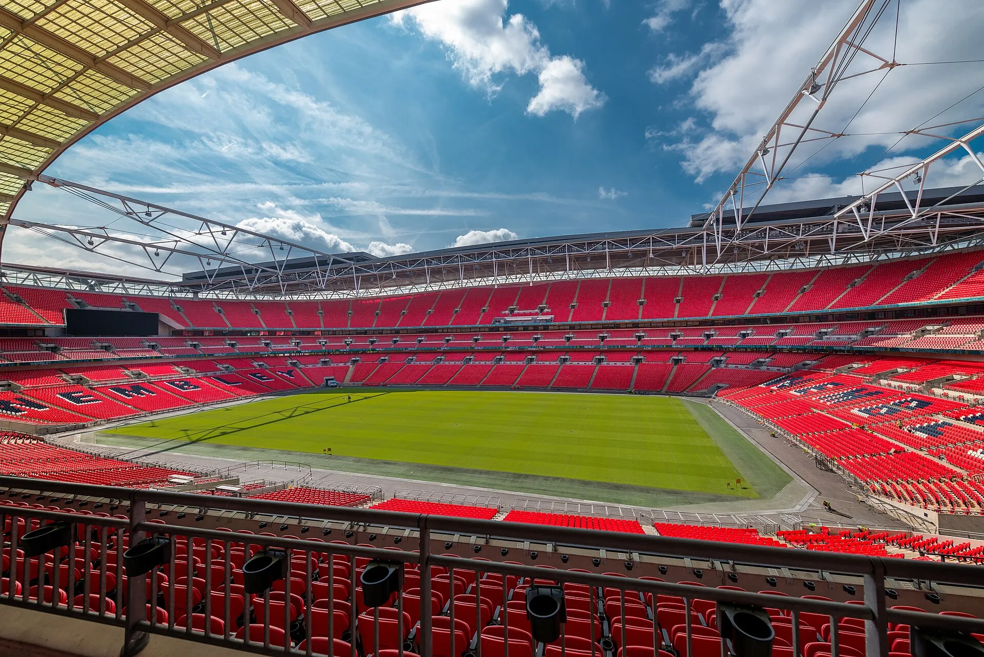 Photograph of the empty Wembley Stadium bowl and pitch in daylight, taken in 2014