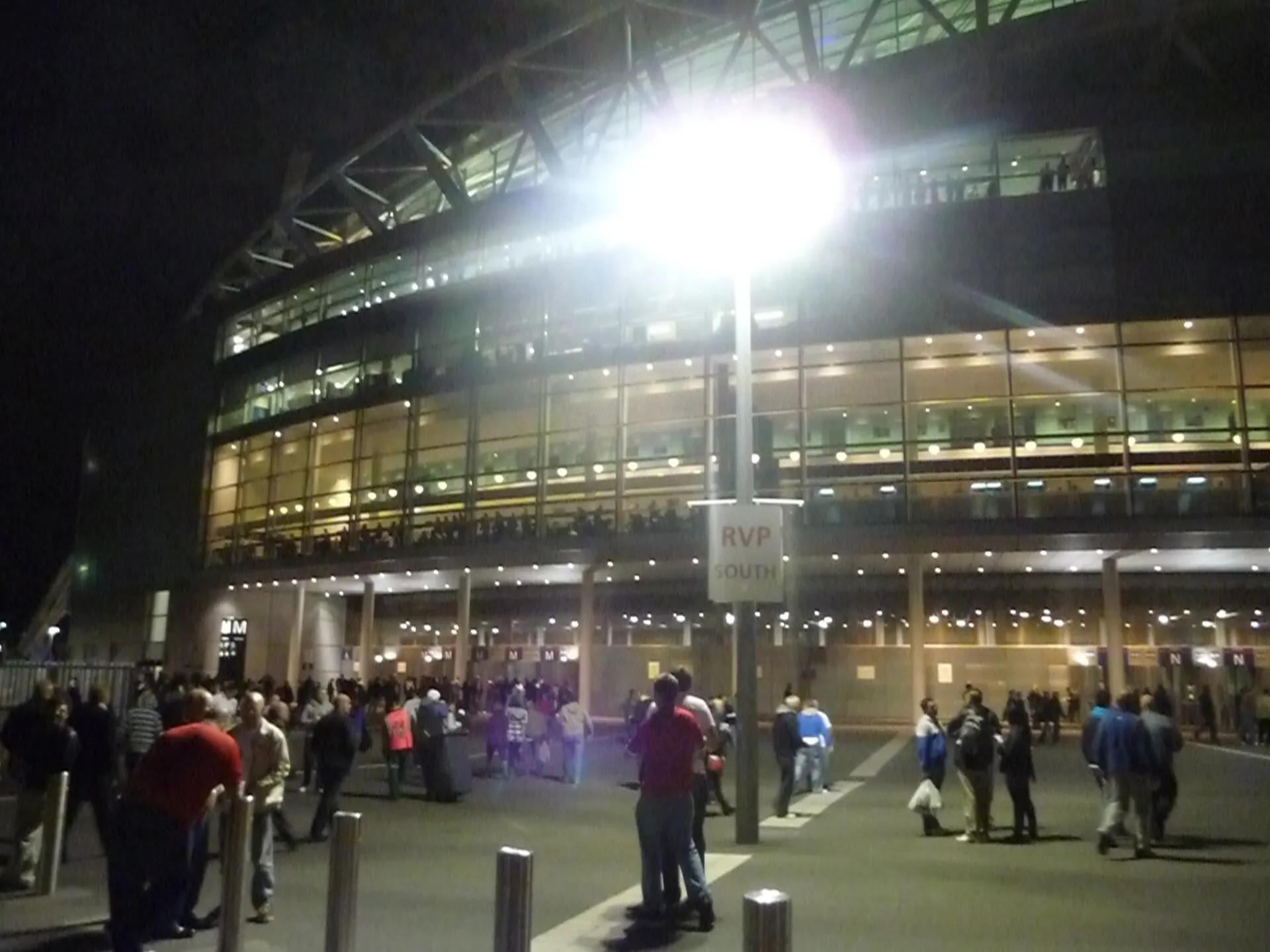 The south side of Wembley Stadium with visitors after dark in 2010