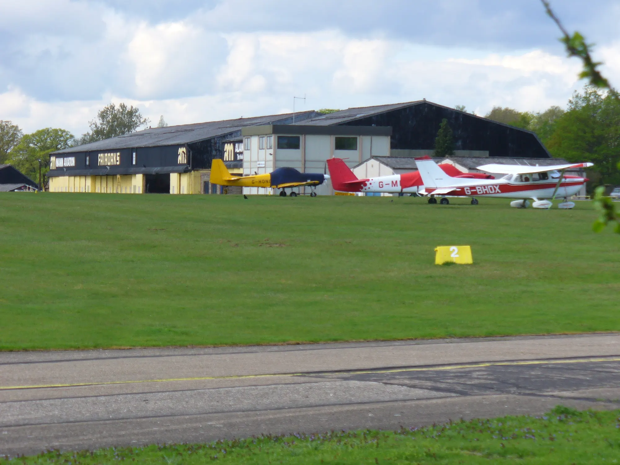 Fairoaks Airport hangar, runway and aircraft in Surrey
